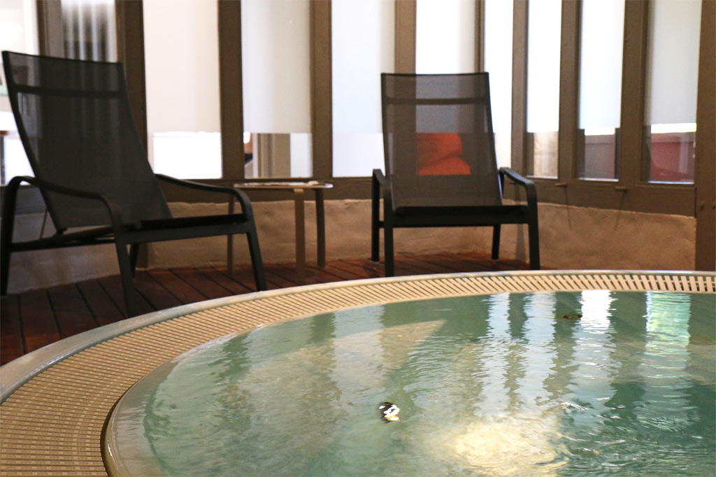 Dans la pièce voisine, le jacuzzi s’anime de remous dans un environnement lumine