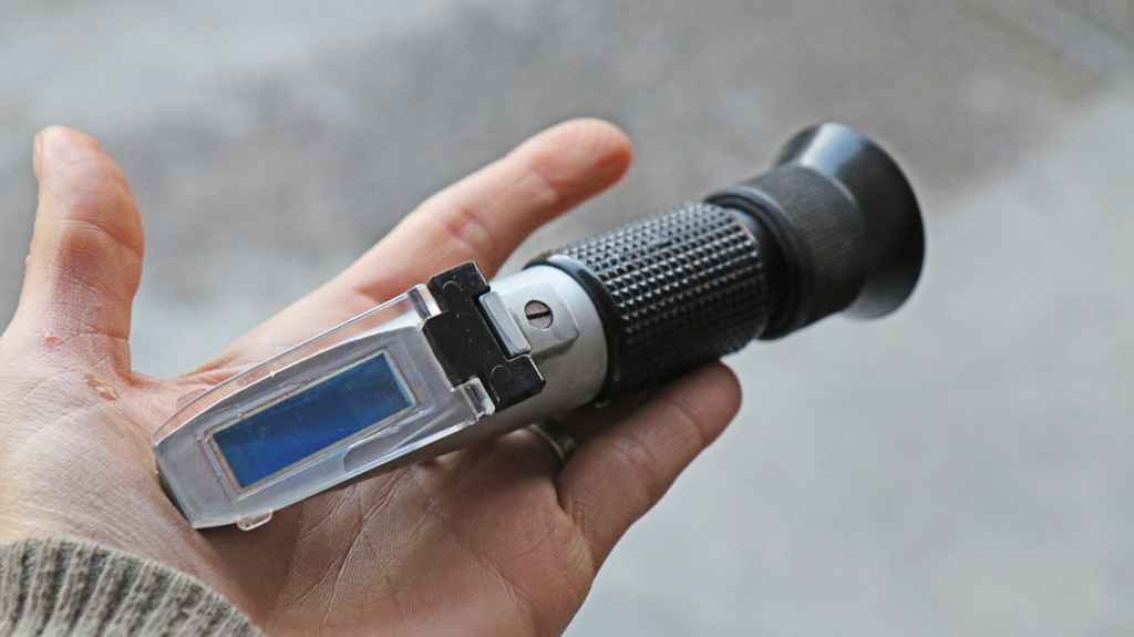 A refractometer to measure sugar content and adjust yeast dosage